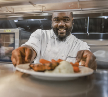 Culinary Employee serving food with a smile