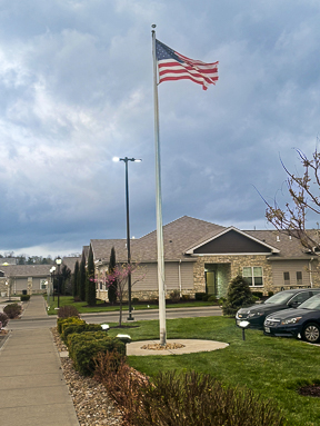 Exterior view at The Madison Senior Living, featuring landscaped grounds.